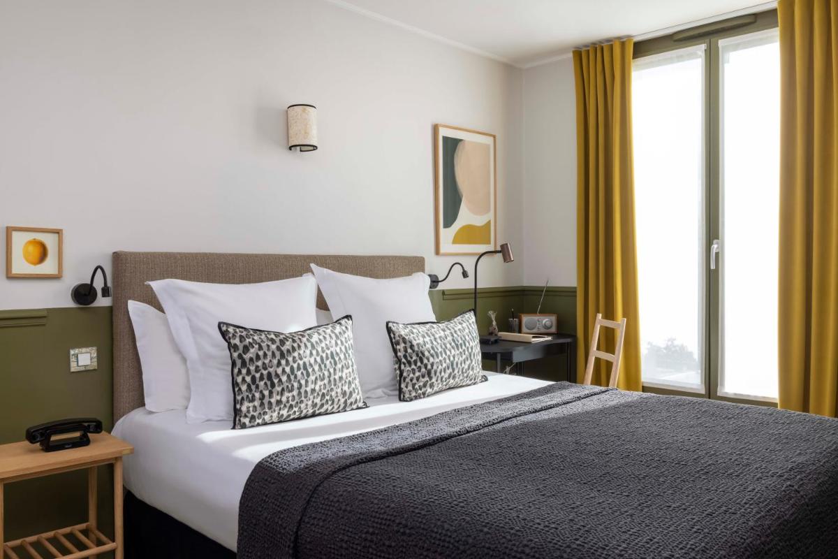 Un ou plusieurs lits dans un hébergement de l'établissement Le Petit Beaumarchais Hotel & Spa