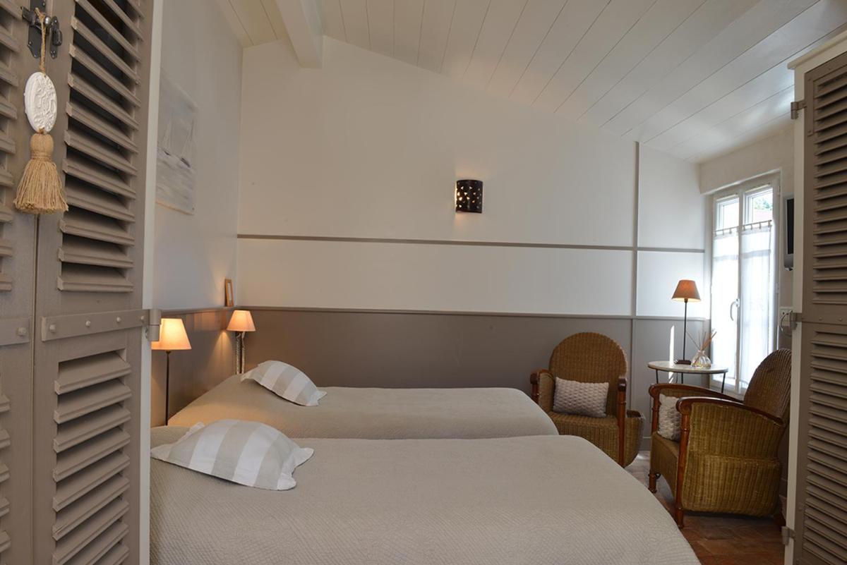 Un ou plusieurs lits dans un hébergement de l'établissement Hotel Les Bois Flottais