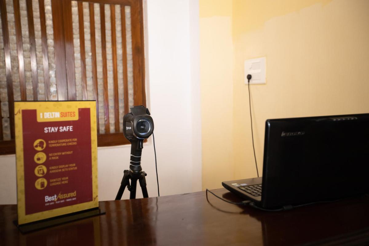 a camera sitting on a table next to a laptop at Deltin Suites in Candolim