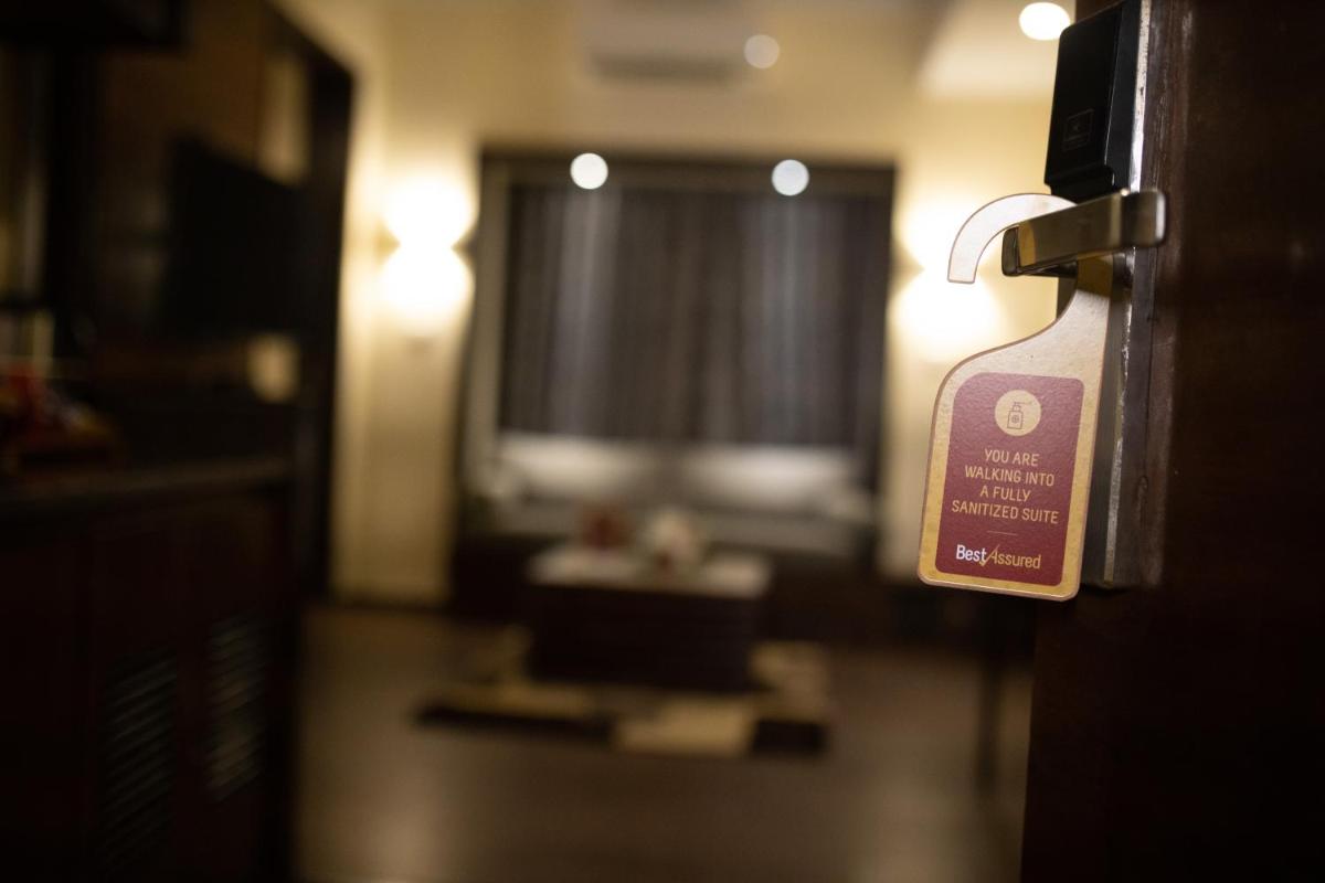a door with a sign on it in a room at Deltin Suites in Candolim