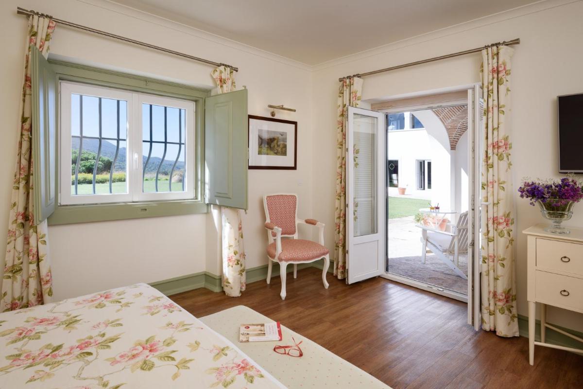 Uma cama ou camas num quarto em Hotel Casa Palmela - Small Luxury Hotels of The World, Hotel & Villas