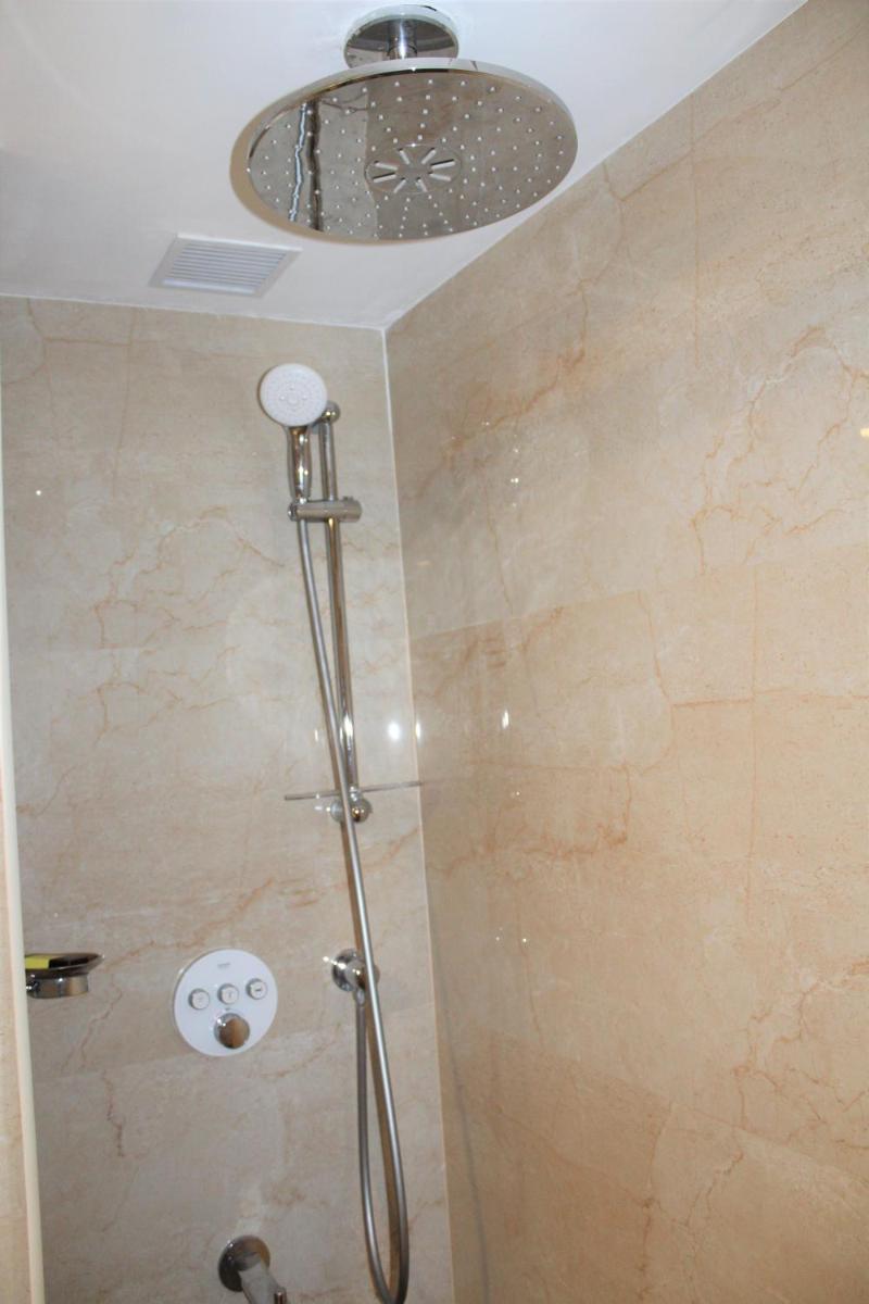 a shower with a shower head in a bathroom at The Accord Metropolitan in Chennai
