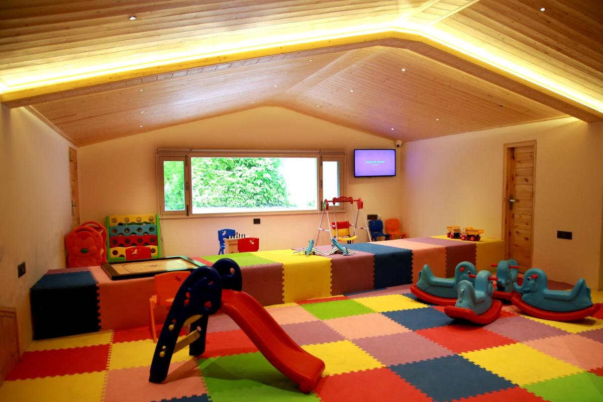 a childrens room with a play area with a slide at The Orchid Shimla in Shimla
