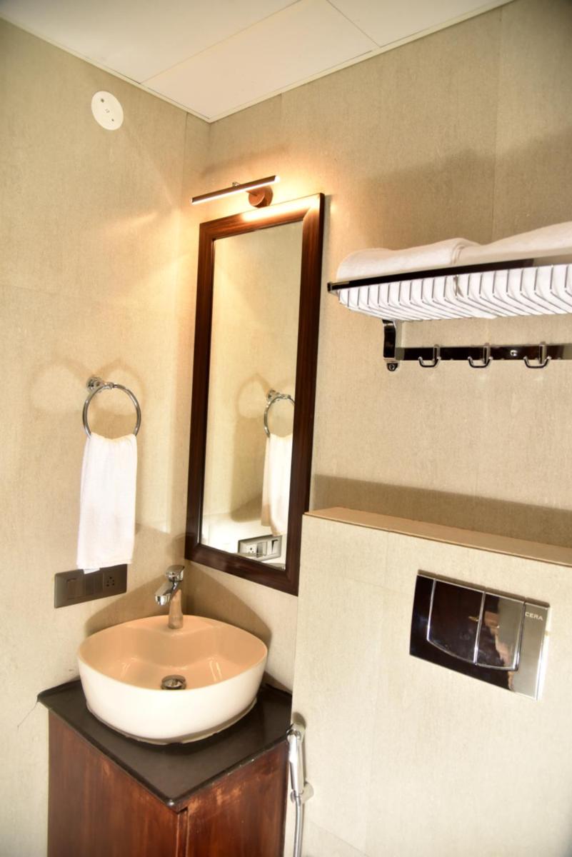 a bathroom with a sink and a bunk bed at The Orchid Shimla in Shimla