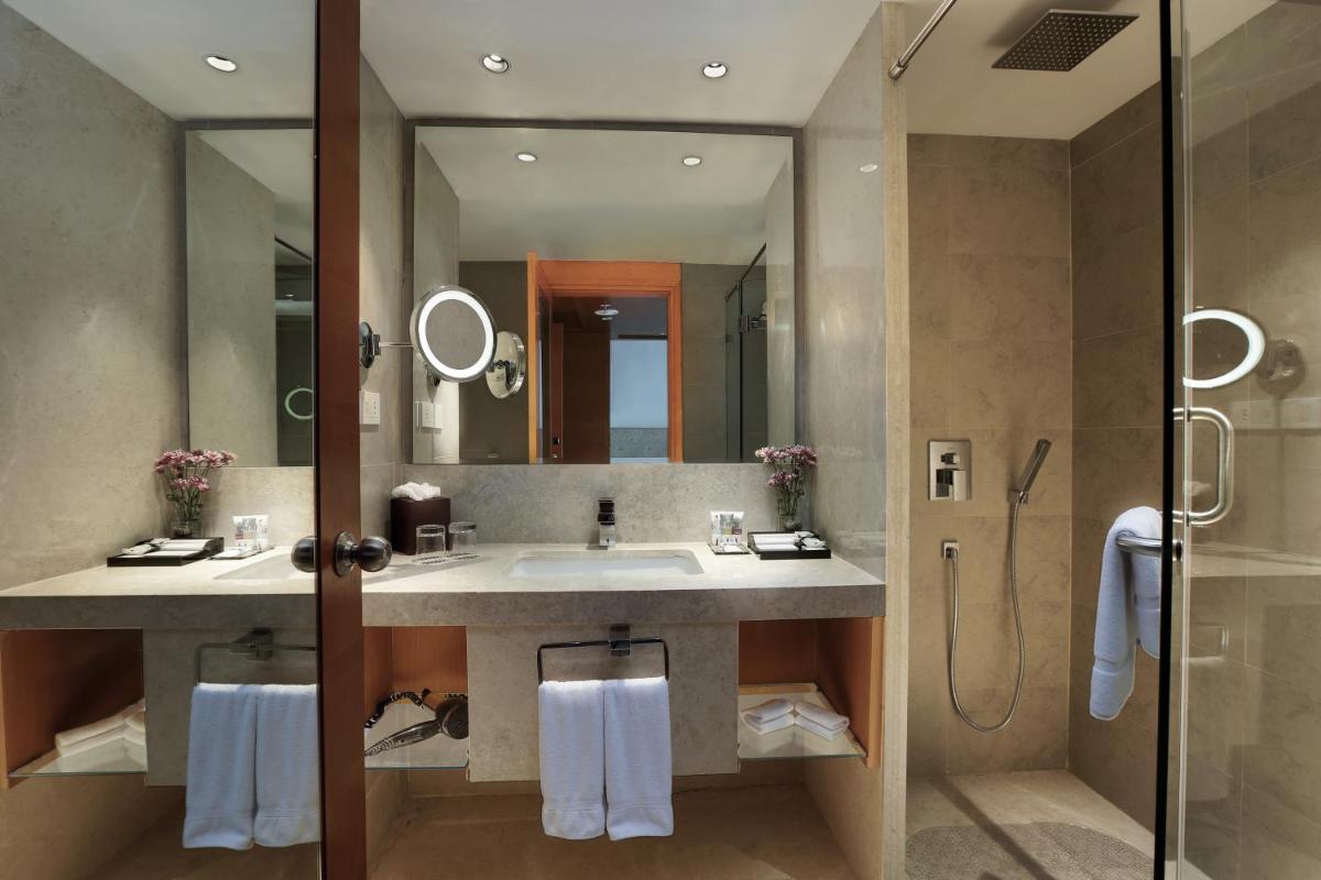 a bathroom with a sink and a shower at Mercure Hyderabad KCP Banjara Hills, An Accor Hotel in Hyderabad