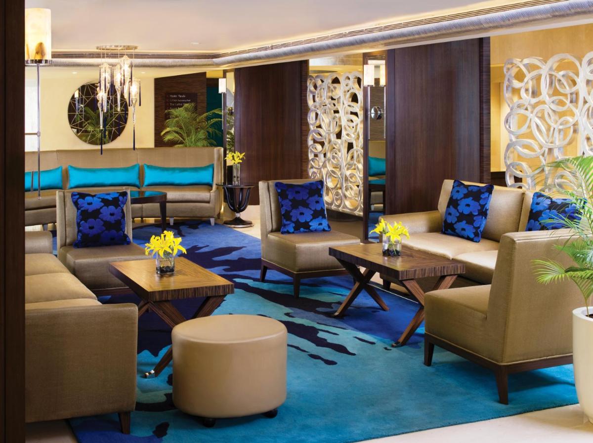 a lobby on a cruise ship with couches and tables at Blue Diamond Pune IHCL SeleQtions in Pune