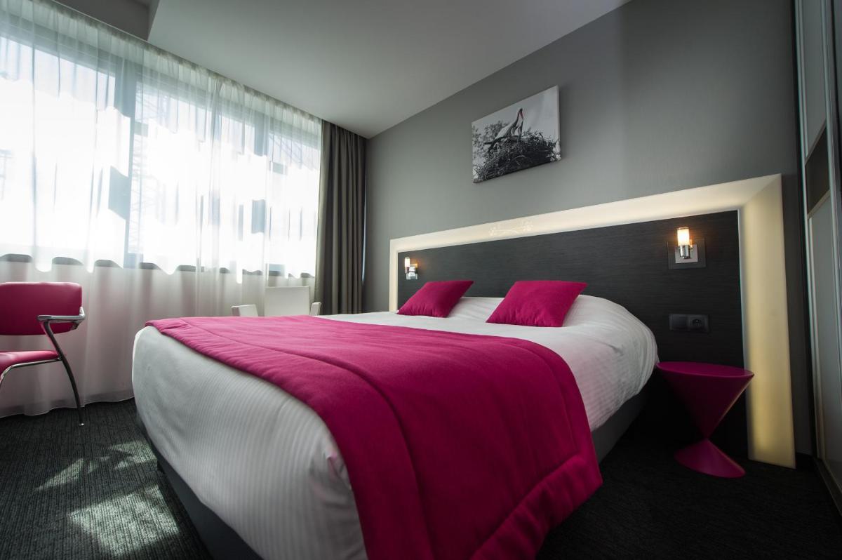 Un ou plusieurs lits dans un hébergement de l'établissement Hôtel Restaurant Athena Spa