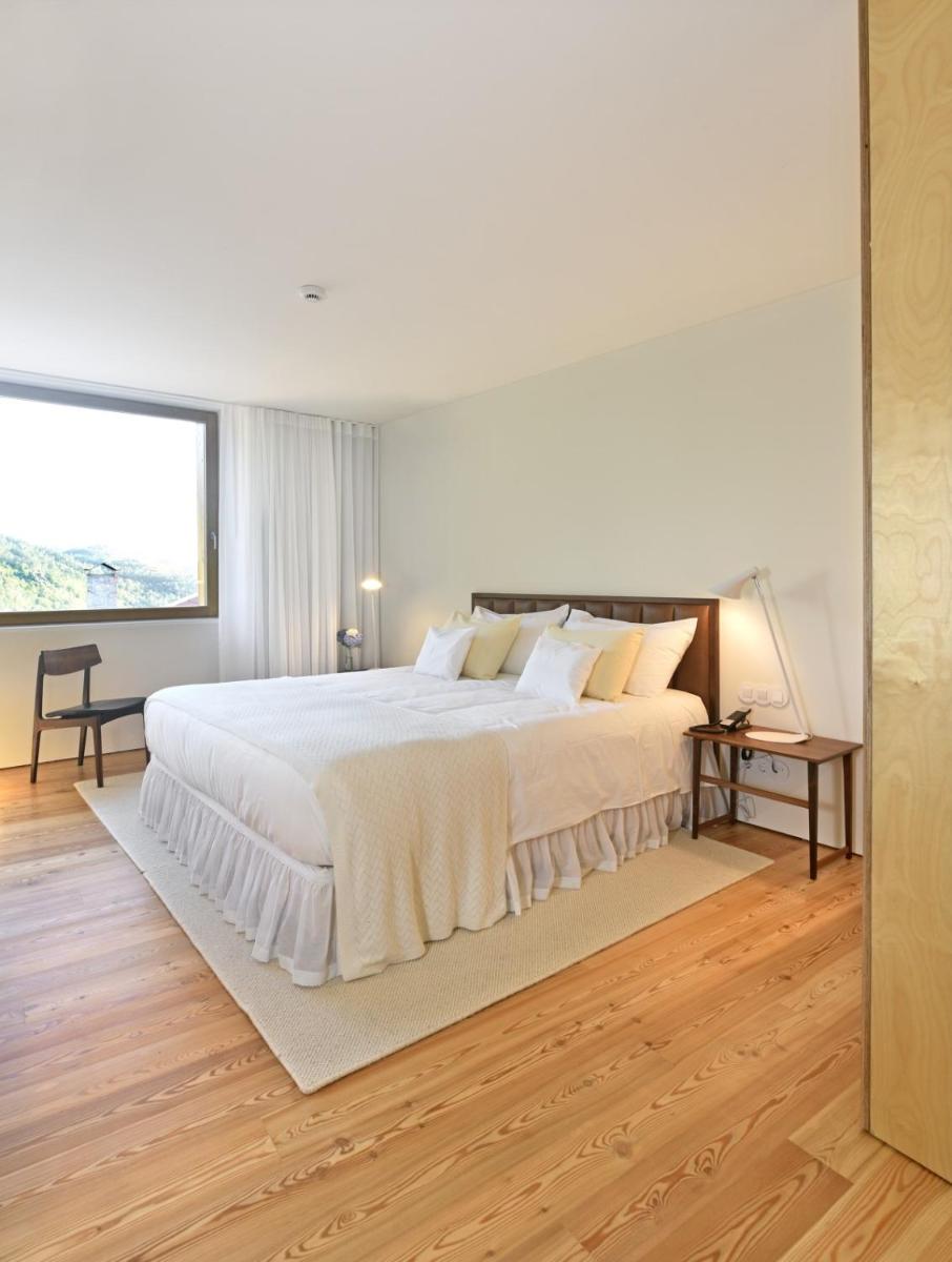 Uma cama ou camas num quarto em Casas Da Lapa, Nature & Spa Hotel