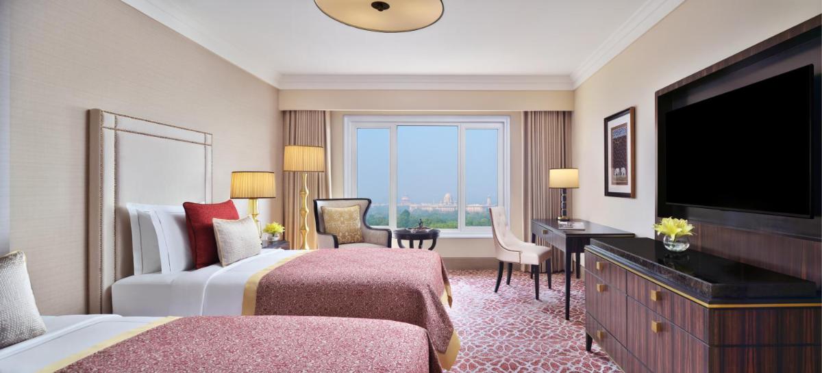 a hotel room with a bed and a flat screen tv at Taj Mahal, New Delhi in New Delhi