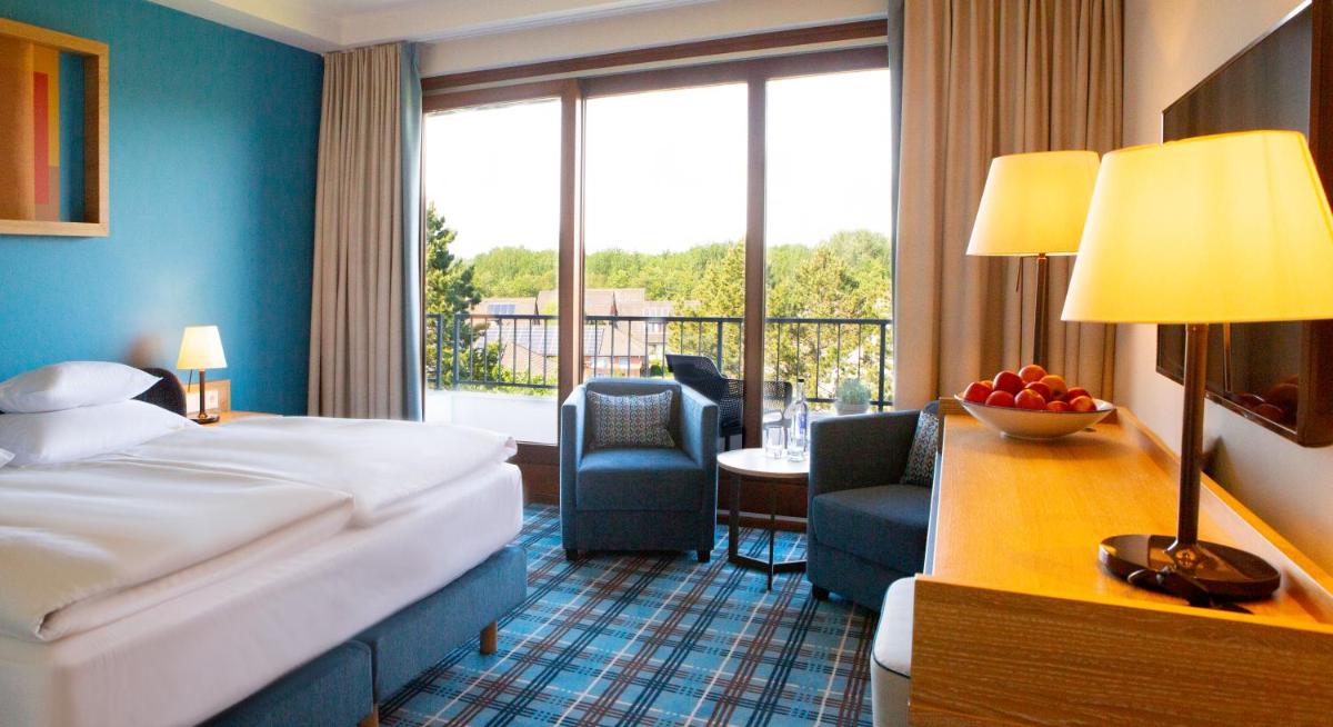 Ein Bett oder Betten in einem Zimmer der Unterkunft Aalernhüs hotel & spa