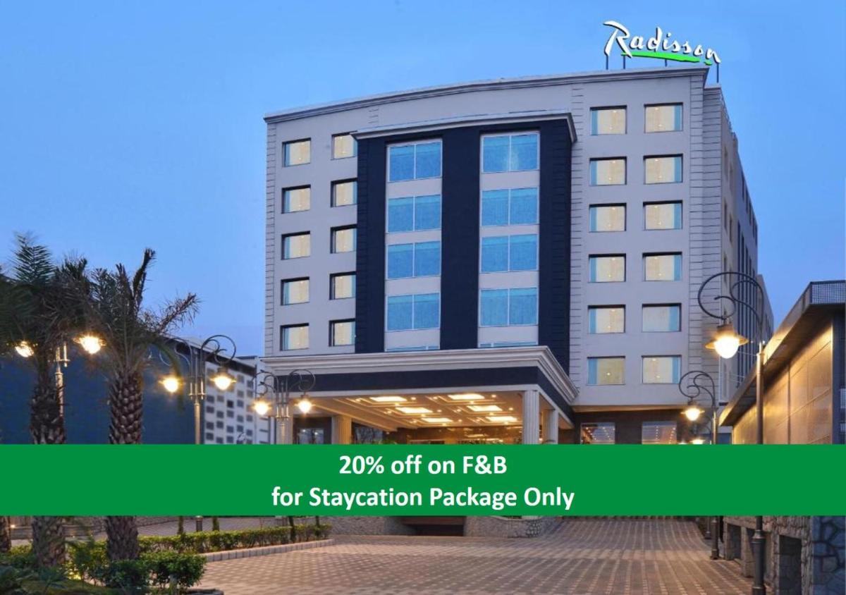 a hotel with a sign on the front of it at Radisson Chandigarh Zirakpur in Chandīgarh