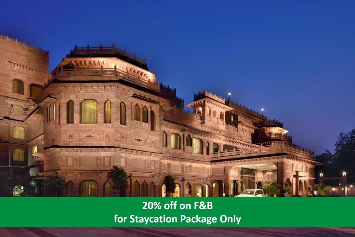 a large stone building with the words off on fbi for vacation package at Radisson Jodhpur in Jodhpur