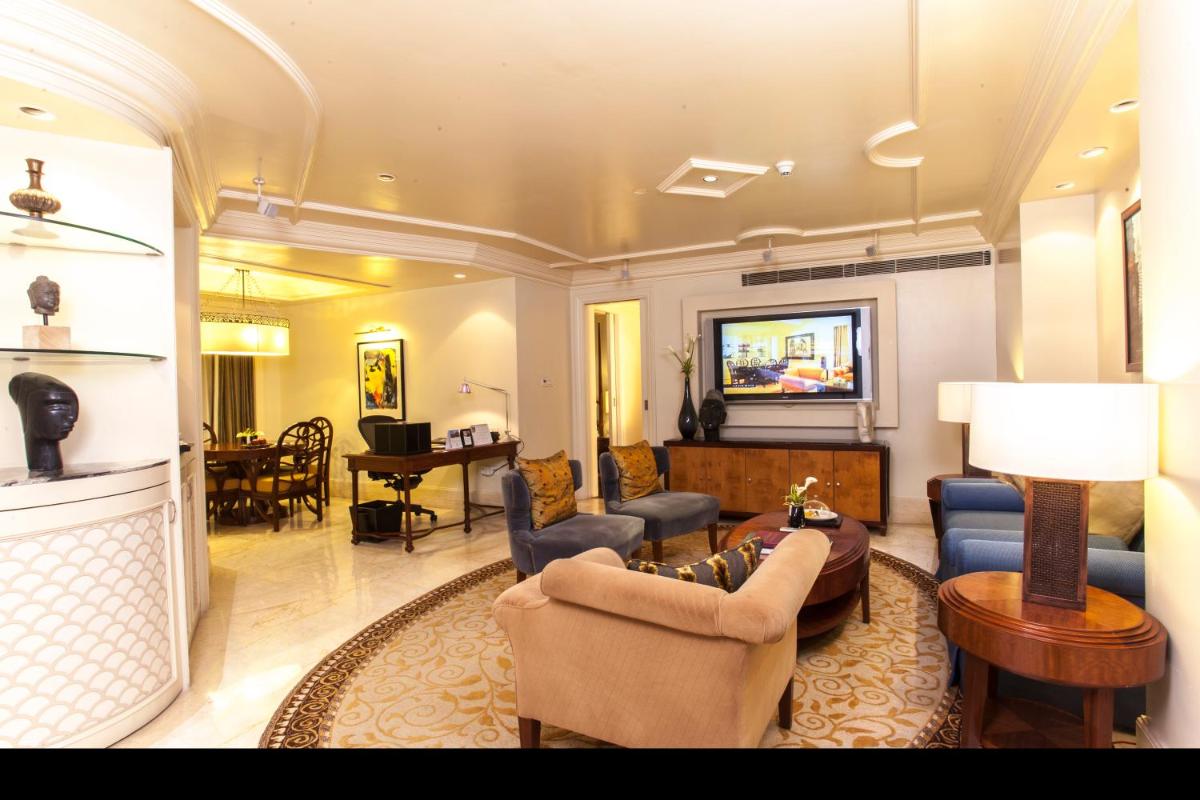 a living room with a couch and chairs and a table at The Claridges New Delhi in New Delhi a living room with a couch and chairs and a table at The Claridges New Delhi in New Delhi
