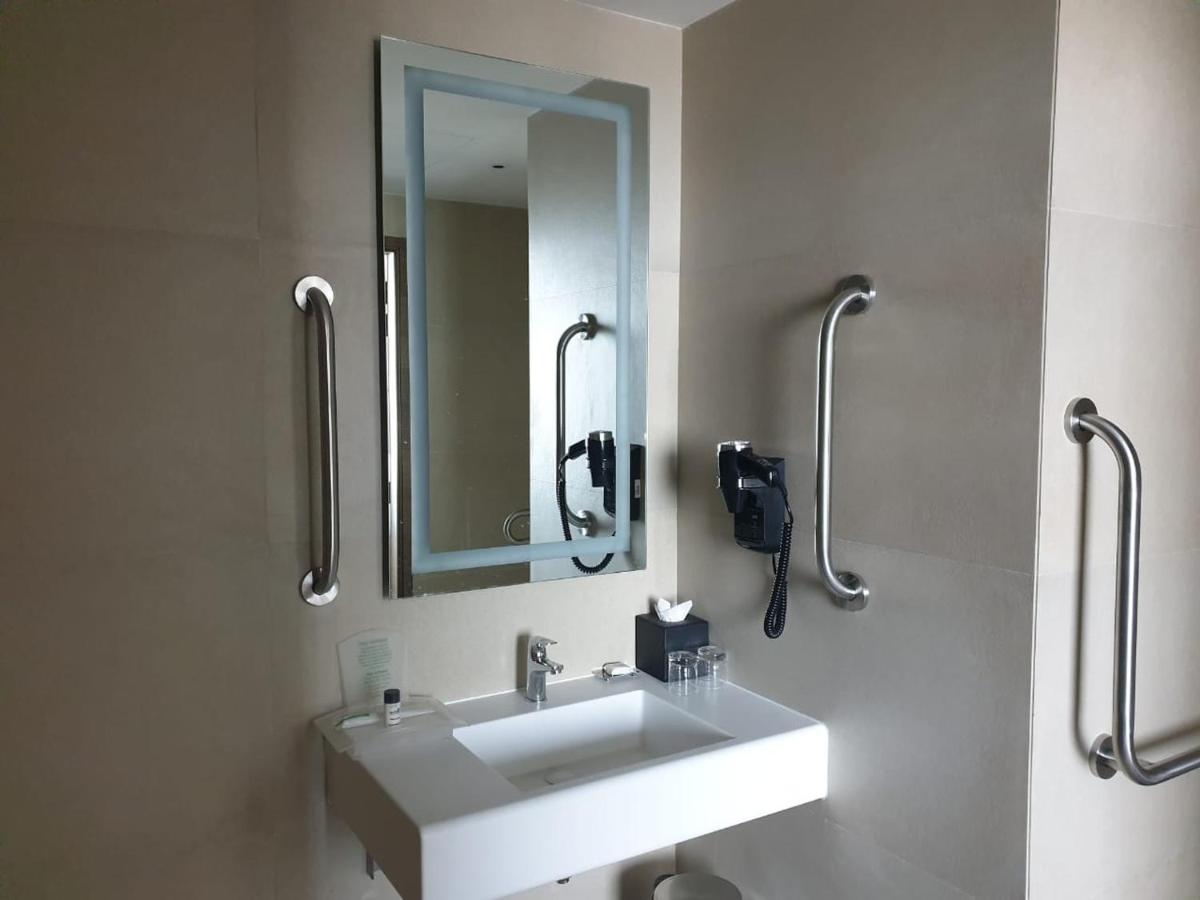 a bathroom with a sink and a mirror at Holiday Inn Gurugram Sector 90 by IHG in Gurgaon