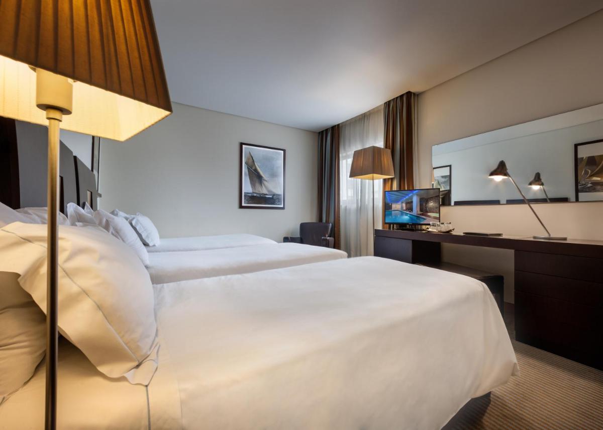 Uma cama ou camas num quarto em Hotel Marina Atlântico