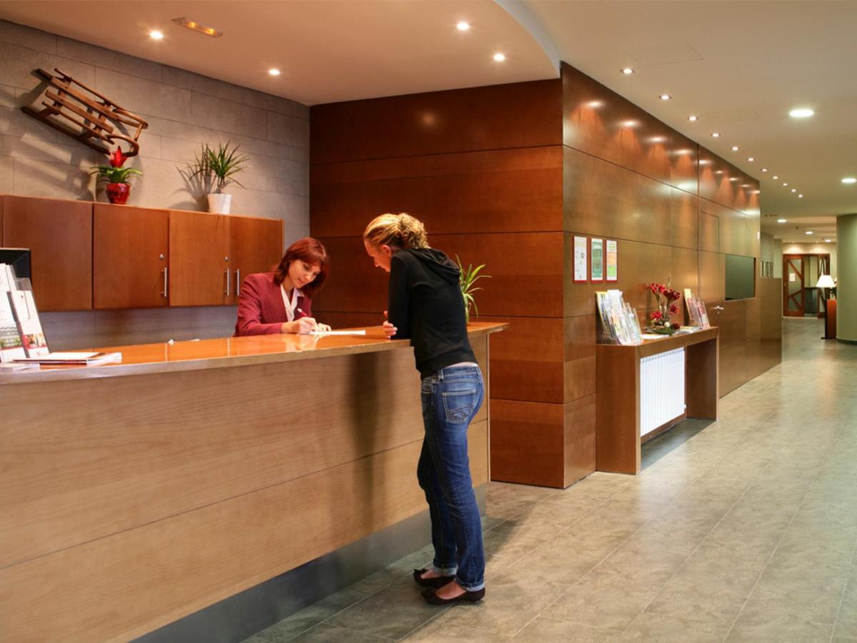 dos mujeres de pie en un mostrador en un vestíbulo en Guitart La Molina Aparthotel & Spa, en La Molina 28 fotos más