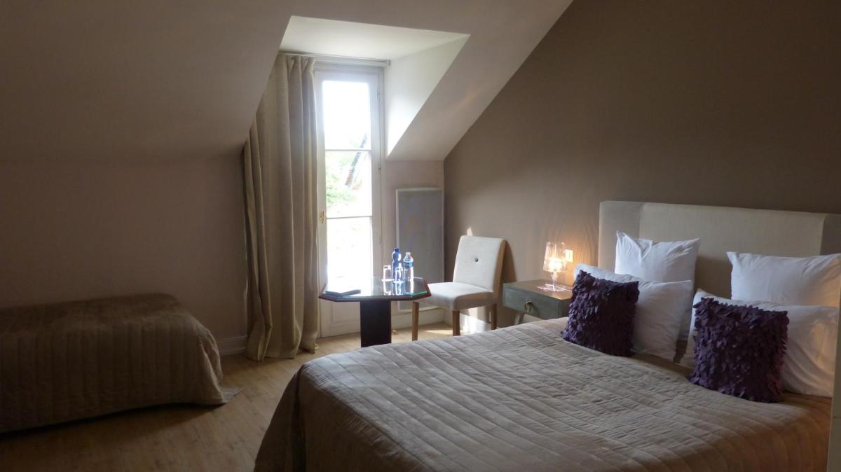 Un ou plusieurs lits dans un hébergement de l'établissement L'Aubinière Hôtel Restaurant & Spa