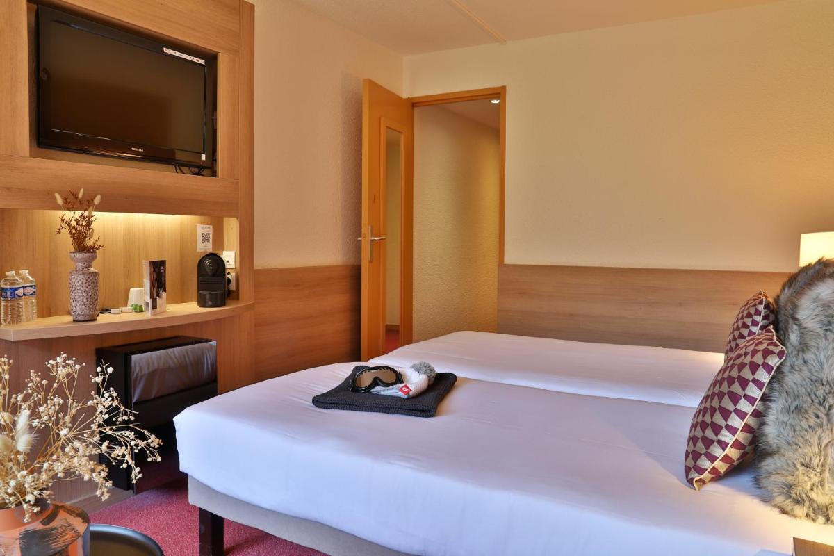 Un ou plusieurs lits dans un hébergement de l'établissement SOWELL HOTELS Mont Blanc et SPA