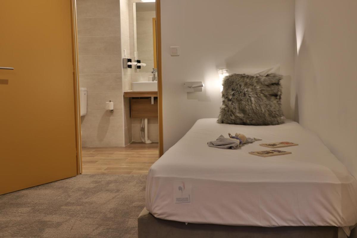 Un ou plusieurs lits dans un hébergement de l'établissement SOWELL HOTELS Mont Blanc et SPA