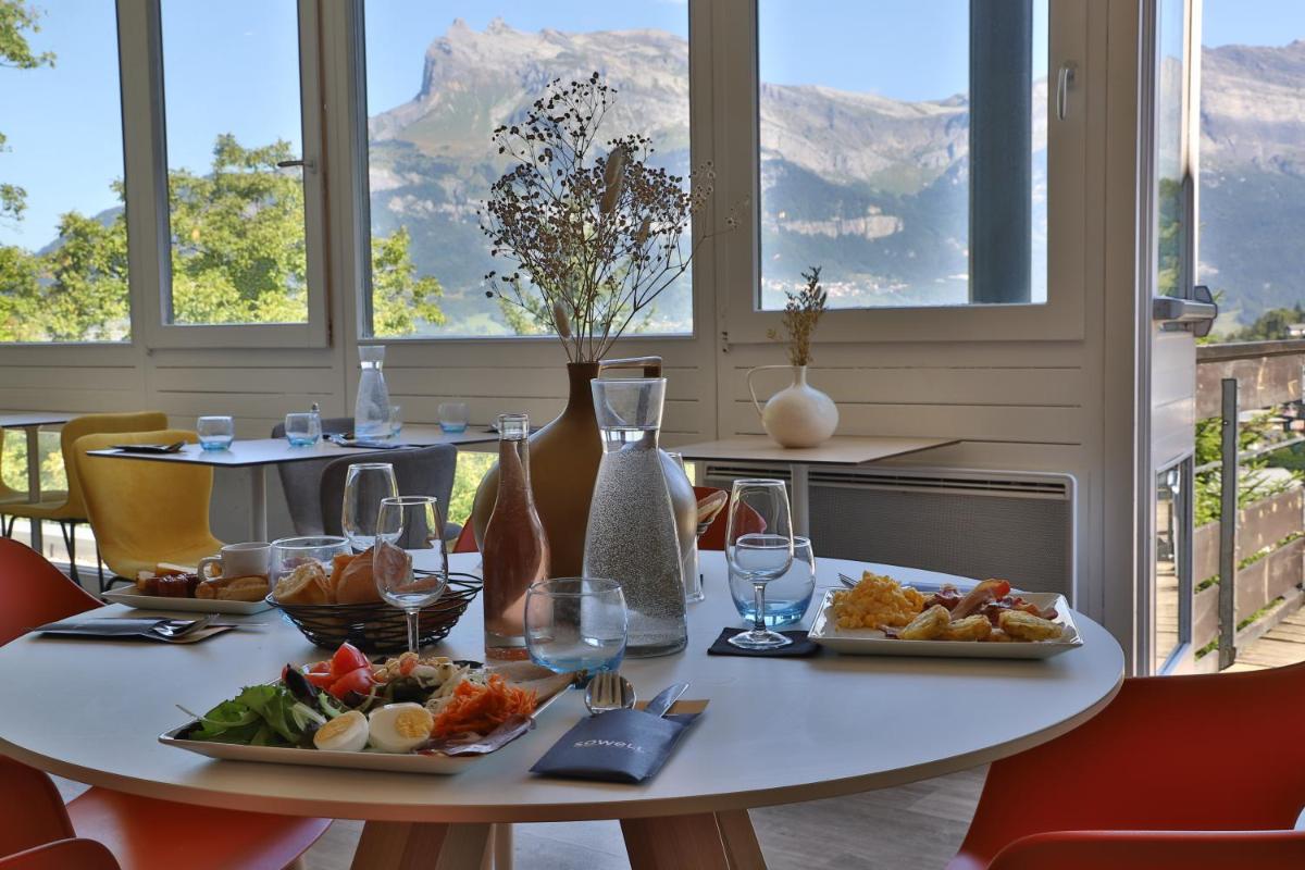 une table avec deux assiettes de nourriture dans l'établissement SOWELL HOTELS Mont Blanc et SPA, à Saint-Gervais-les-Bains