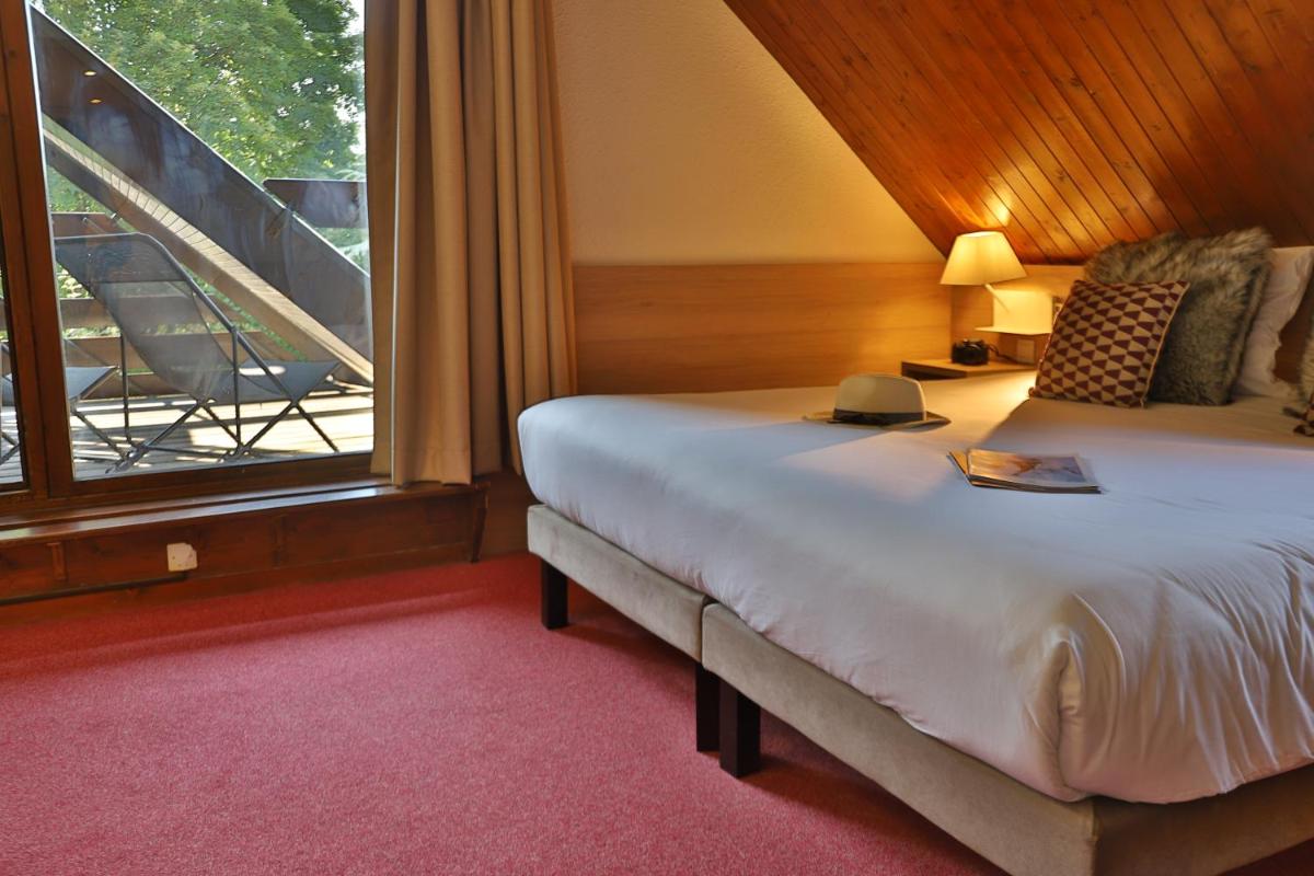 Un ou plusieurs lits dans un hébergement de l'établissement SOWELL HOTELS Mont Blanc et SPA