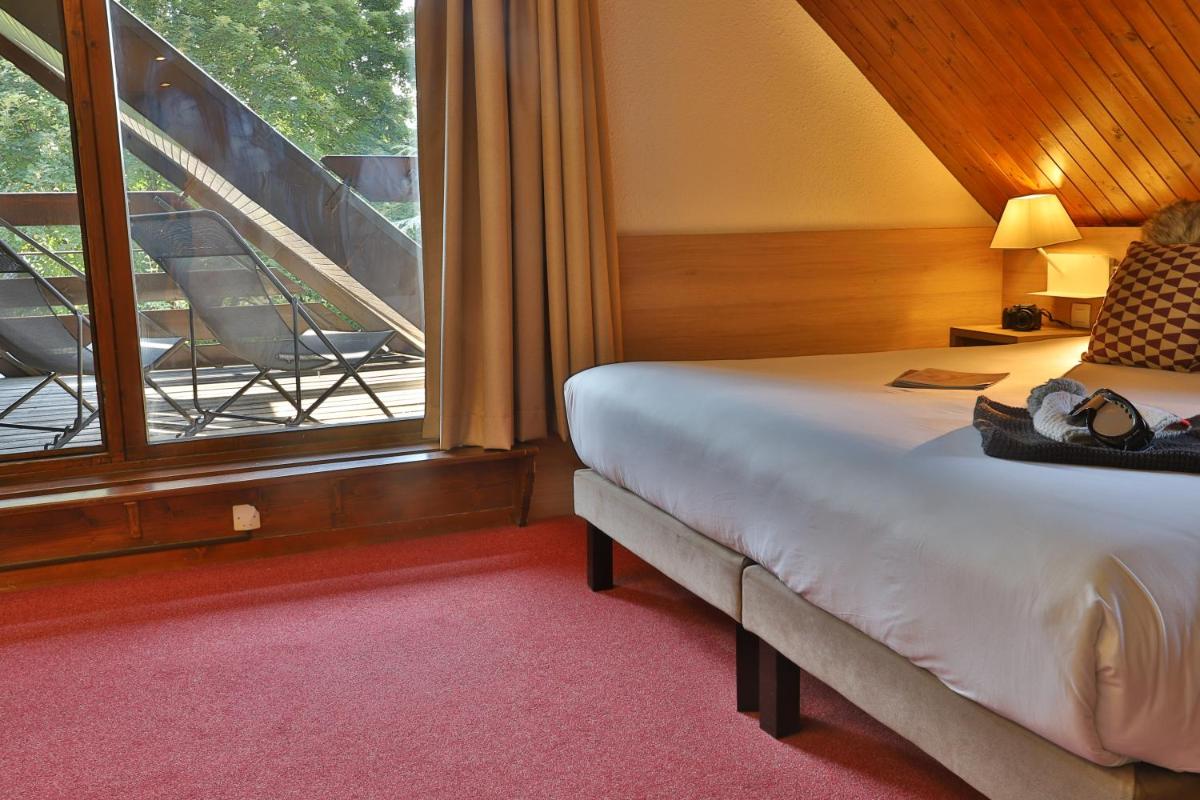 Un ou plusieurs lits dans un hébergement de l'établissement SOWELL HOTELS Mont Blanc et SPA