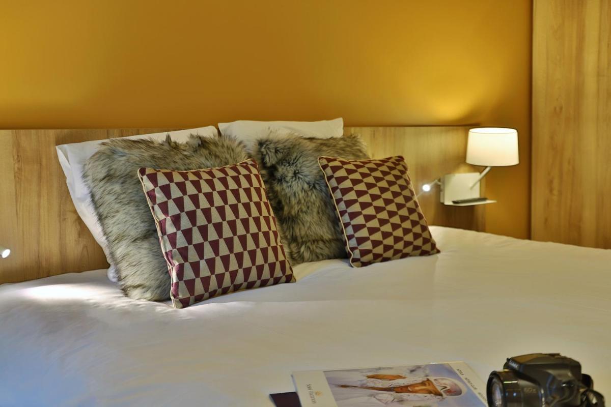 Un ou plusieurs lits dans un hébergement de l'établissement SOWELL HOTELS Mont Blanc et SPA