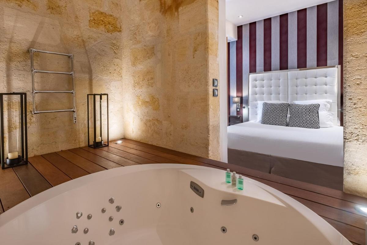 Un ou plusieurs lits dans un hébergement de l'établissement Le Boutique Hotel & Spa