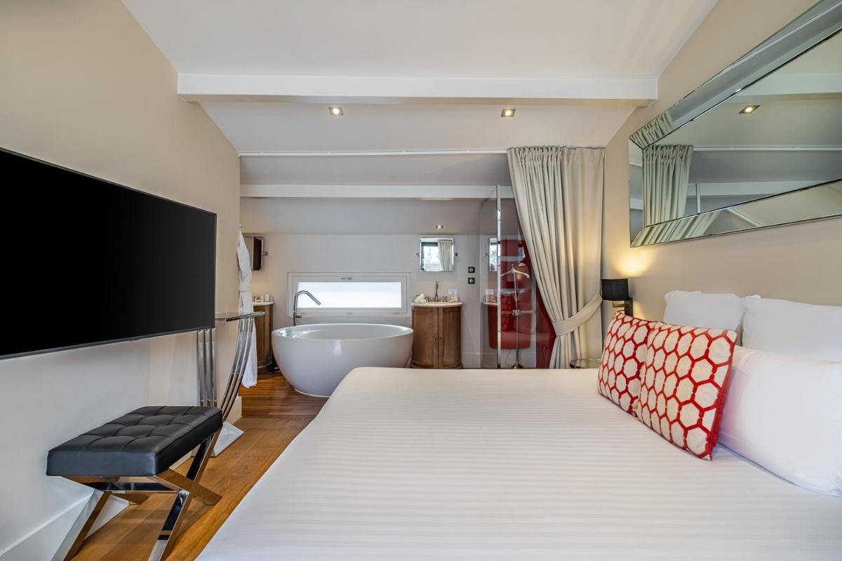 Un ou plusieurs lits dans un hébergement de l'établissement Le Boutique Hotel & Spa