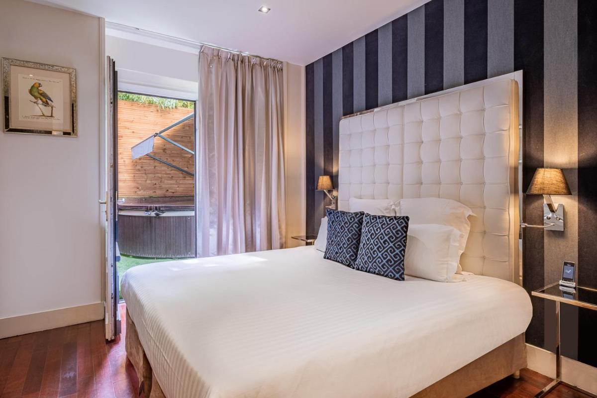 Un ou plusieurs lits dans un hébergement de l'établissement Le Boutique Hotel & Spa