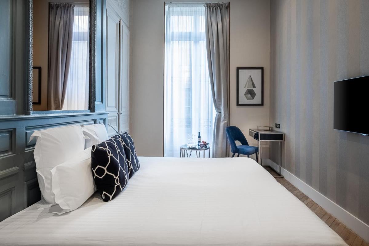 Un ou plusieurs lits dans un hébergement de l'établissement Le Boutique Hotel & Spa