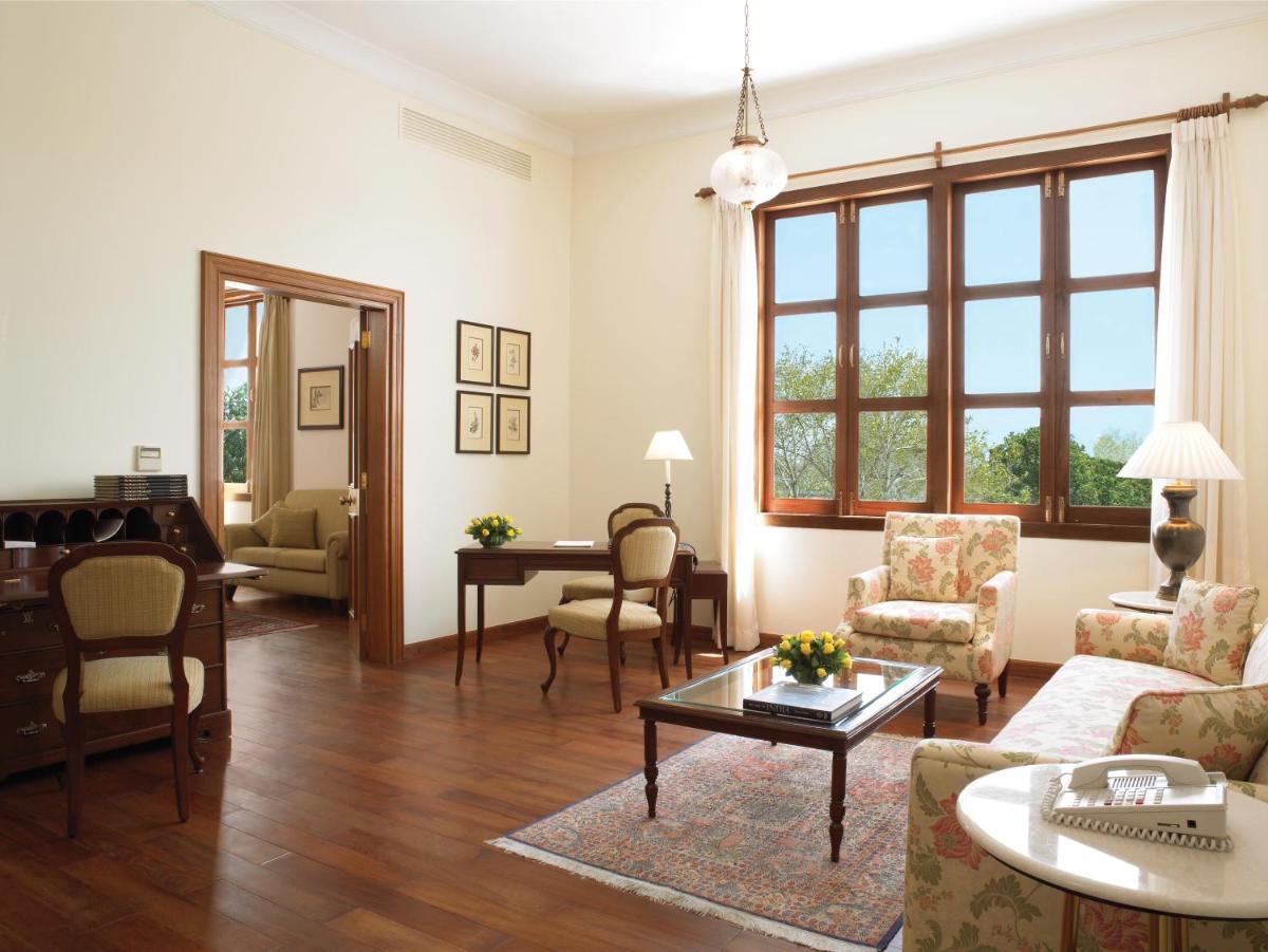 a living room with a couch and a table at Maidens Hotel New Delhi in New Delhi