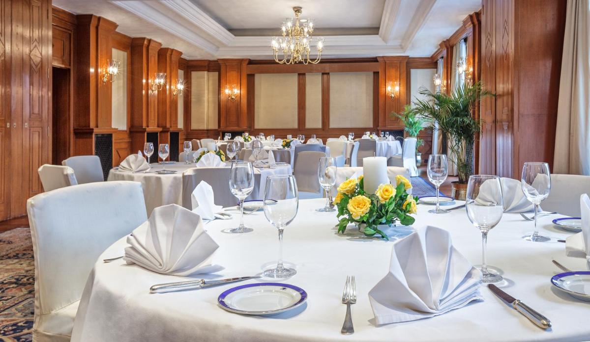 a conference room with white tables and white chairs at Wildflower Hall, An Oberoi Resort, Shimla in Shimla