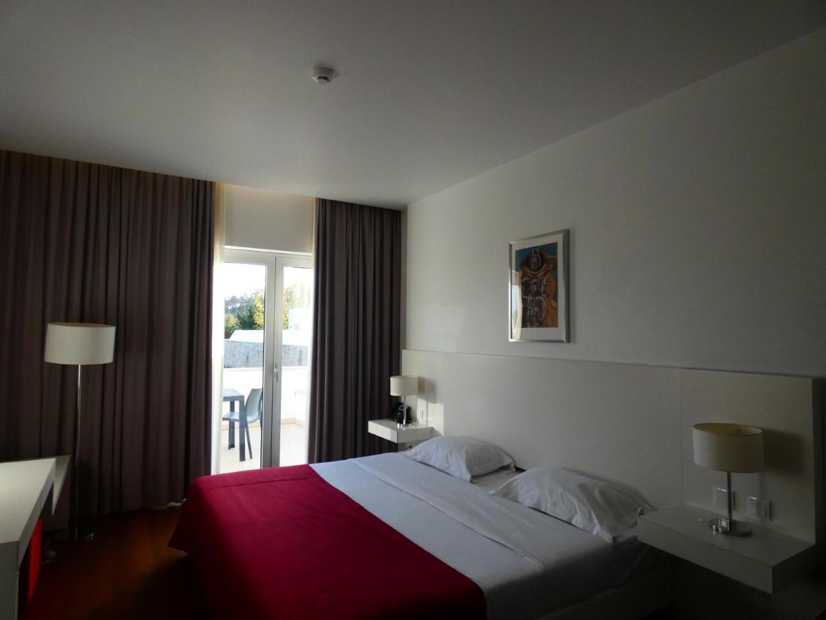 Uma cama ou camas num quarto em Hotel Vila D'Óbidos