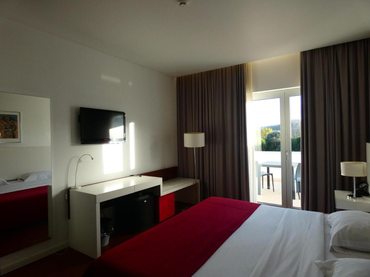Uma cama ou camas num quarto em Hotel Vila D'Óbidos