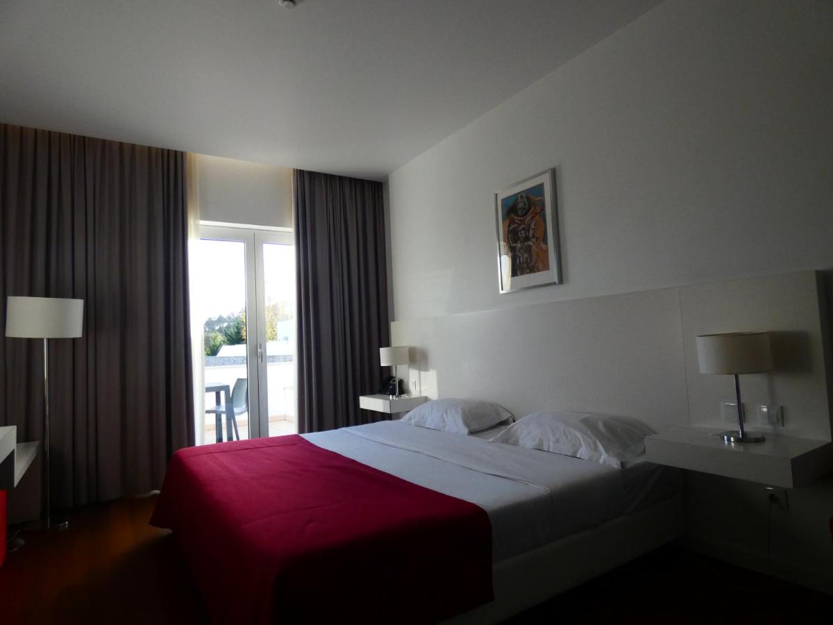 Uma cama ou camas num quarto em Hotel Vila D'Óbidos
