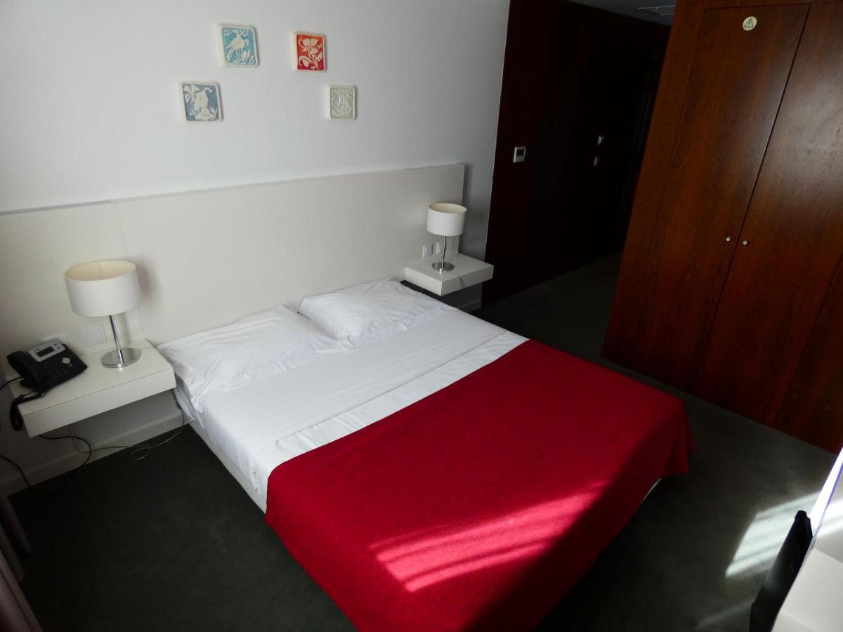 Uma cama ou camas num quarto em Hotel Vila D'Óbidos