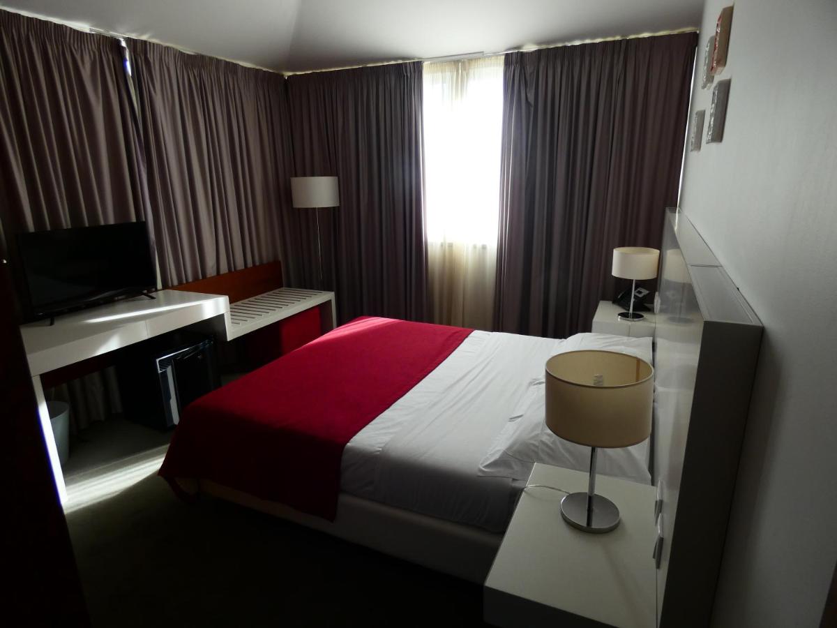 Uma cama ou camas num quarto em Hotel Vila D'Óbidos