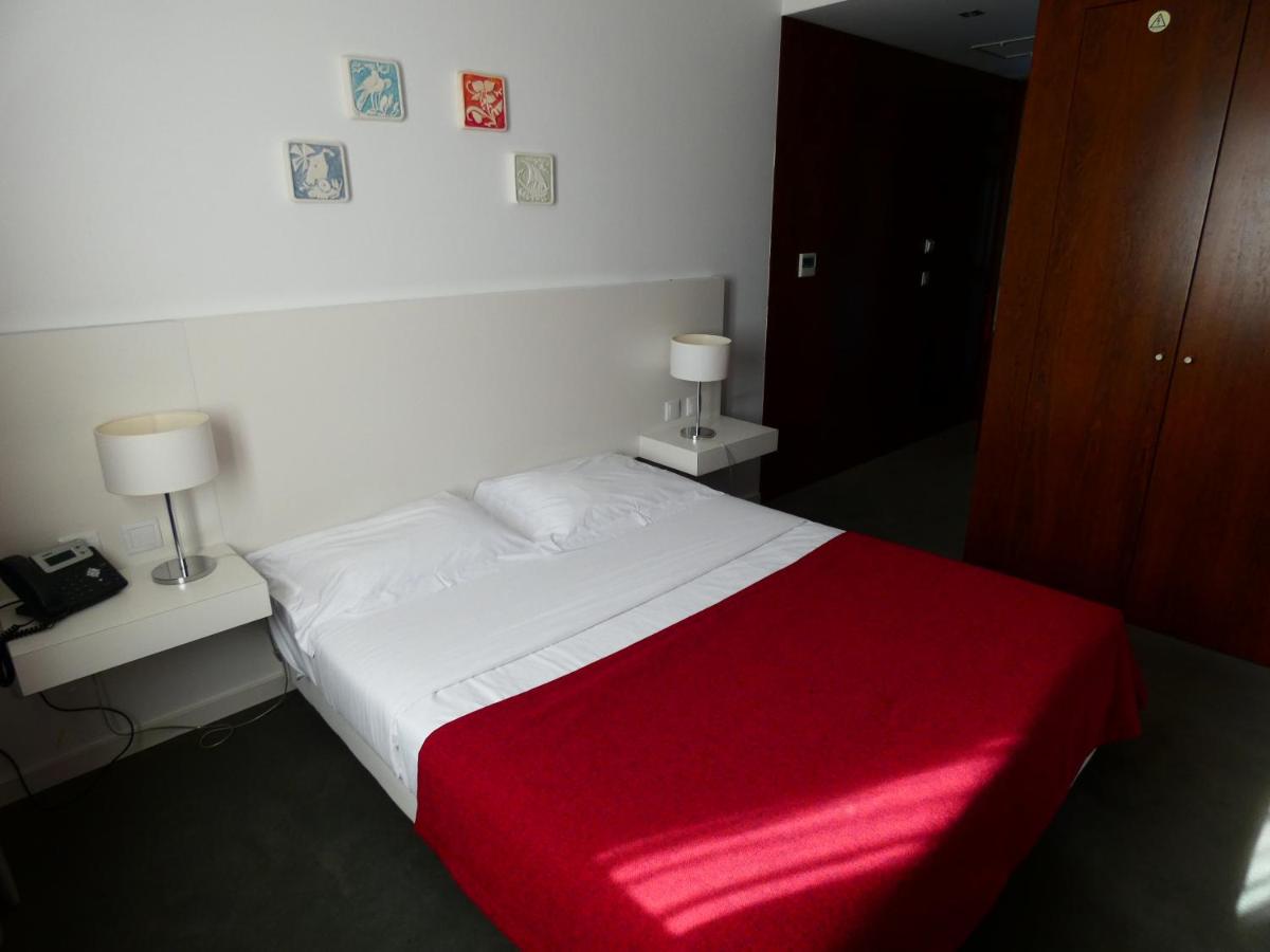 Uma cama ou camas num quarto em Hotel Vila D'Óbidos