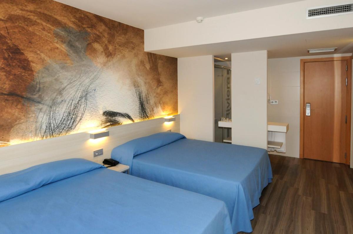 Cama o camas de una habitación en Hotel Riviera