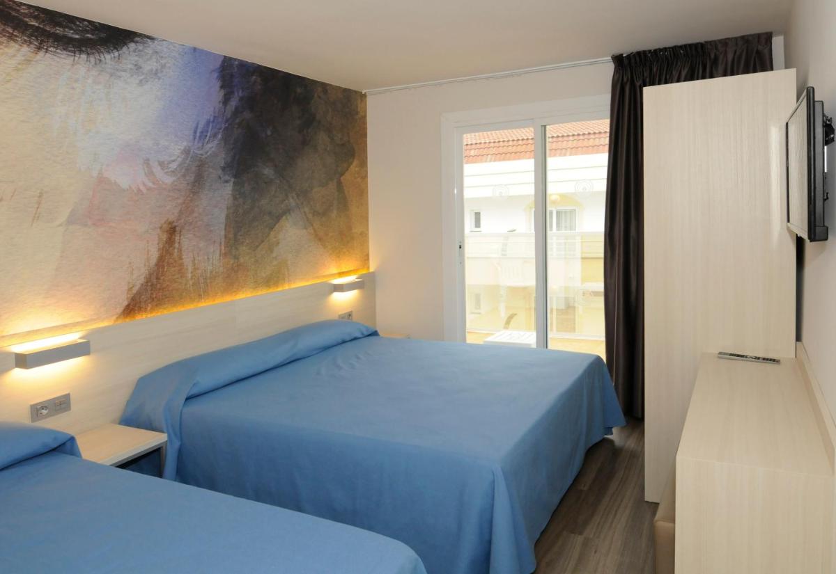 Cama o camas de una habitación en Hotel Riviera