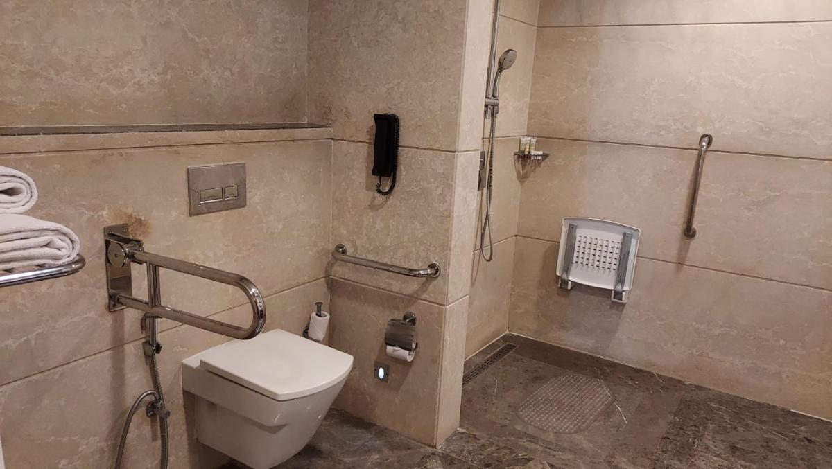 a bathroom with a toilet and a shower at InterContinental Jaipur Tonk Road by IHG in Jaipur