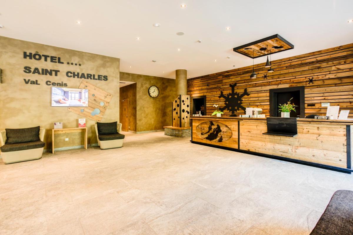 - un hall d'un hôtel avec deux chaises et un comptoir dans l'établissement Hôtel Saint Charles Val Cenis, à Lanslebourg-Mont-Cenis