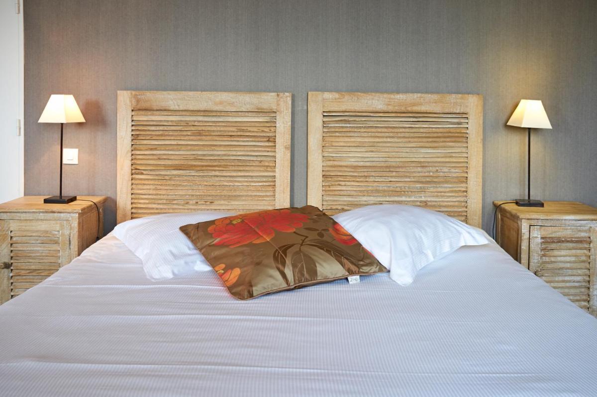 Un ou plusieurs lits dans un hébergement de l'établissement Almoria Hôtel & SPA