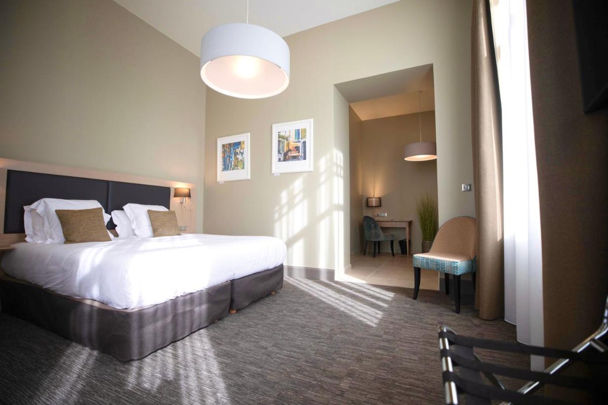 Un ou plusieurs lits dans un hébergement de l'établissement Hôtel Spa Marotte