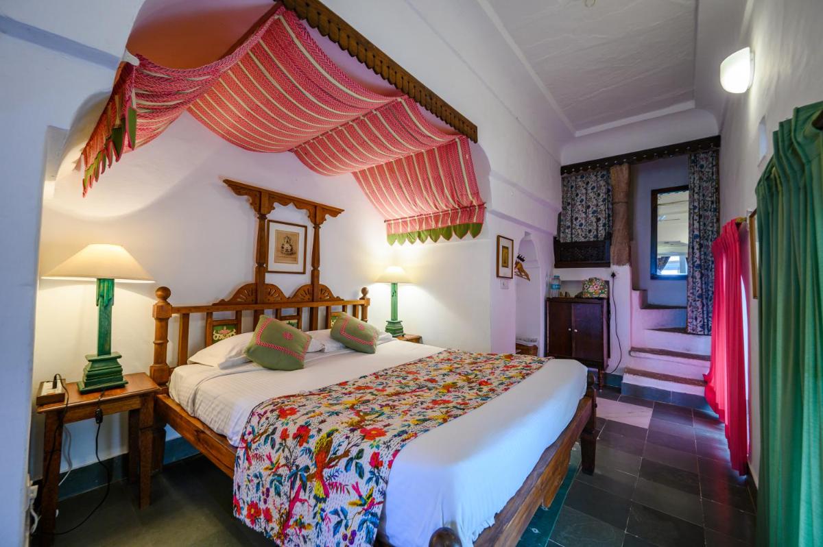 a bedroom with a bed with a canopy at Neemrana Fort-Palace in Neemrana
