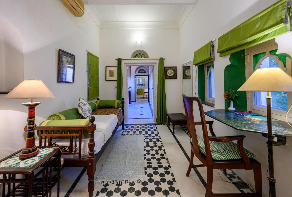 a living room with a couch and a table at Neemrana Fort-Palace in Neemrana