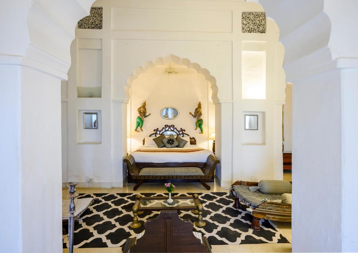 a bedroom with a king sized bed in a room at Neemrana Fort-Palace in Neemrana