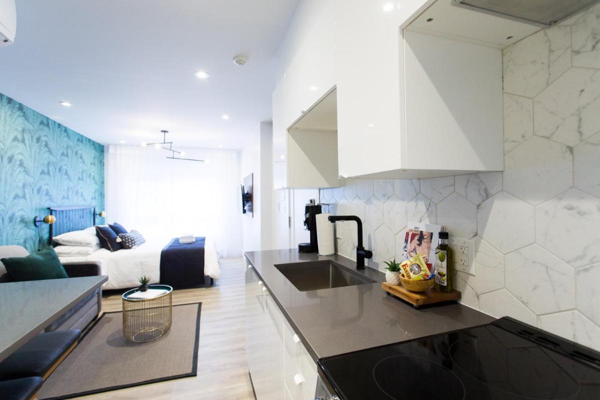 Studio Palms Steps from JeanTalon Market Full Bath by Den Stays - Housity