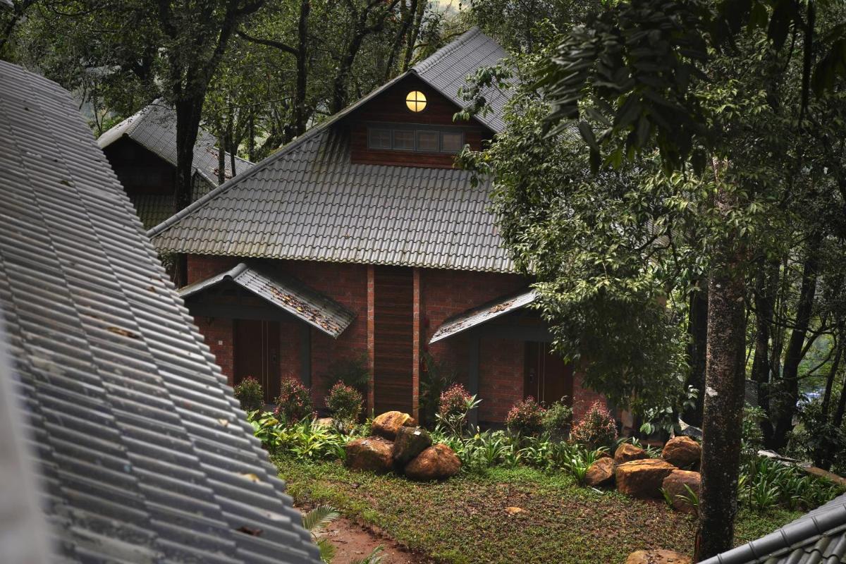 a house with a light on the top of it at Elephant Passage in Munnar
